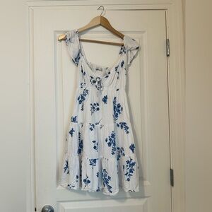 Holster short floral dress with peephole in front and tie.